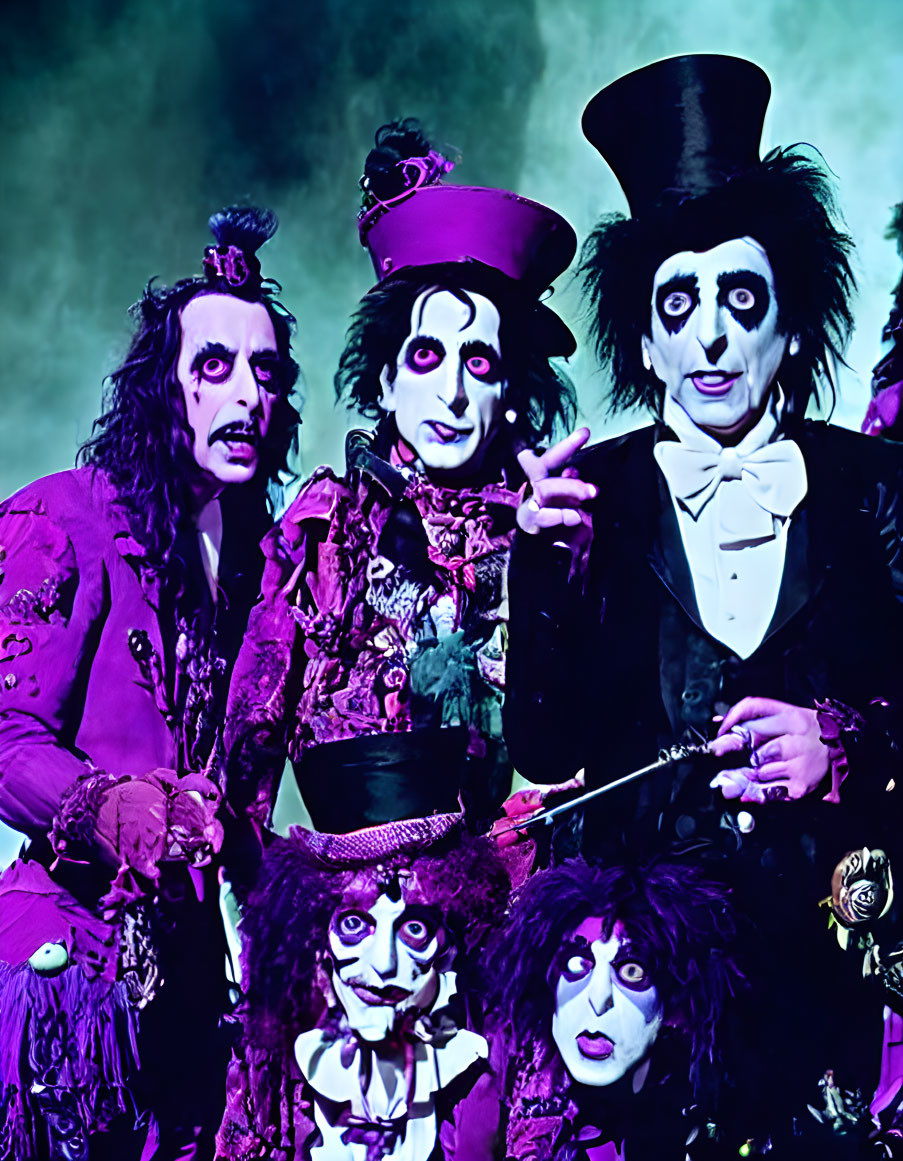 Three individuals in Gothic clown attire with white face makeup and eccentric hats.