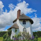 Round Blue Fairytale Cottage Illustration with Thatched Roof