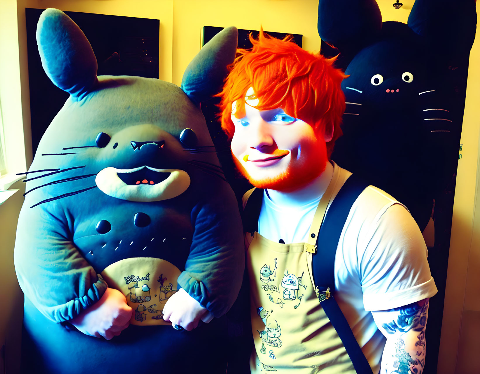 Reddish-Haired Person Smiling with Gray Animated Plush in Art-Filled Room