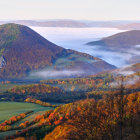Autumn sunrise landscape: misty hills and foggy valleys.