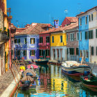 Vibrant Venice-like canal with colorful houses and boats under blue sky