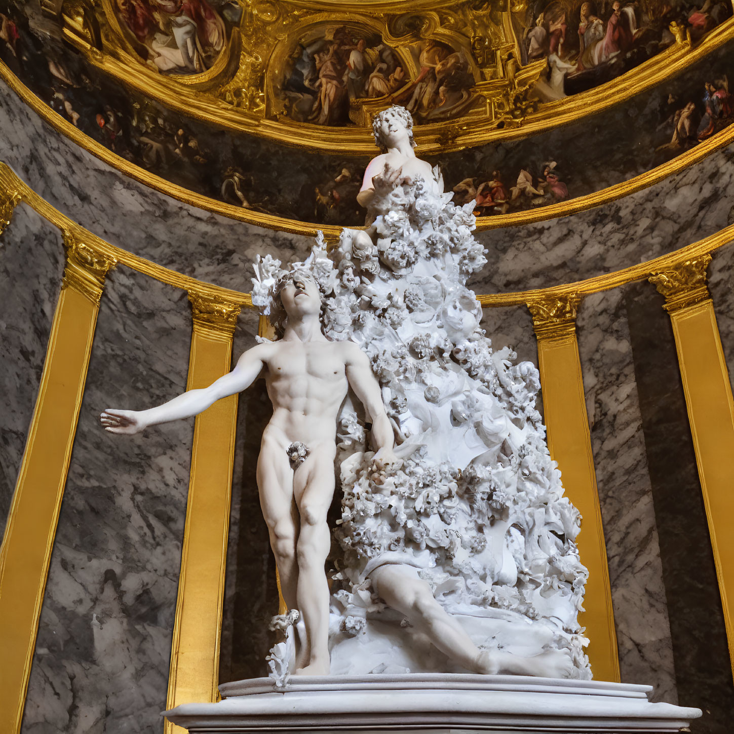 Classical male sculpture with cherub in ornate setting