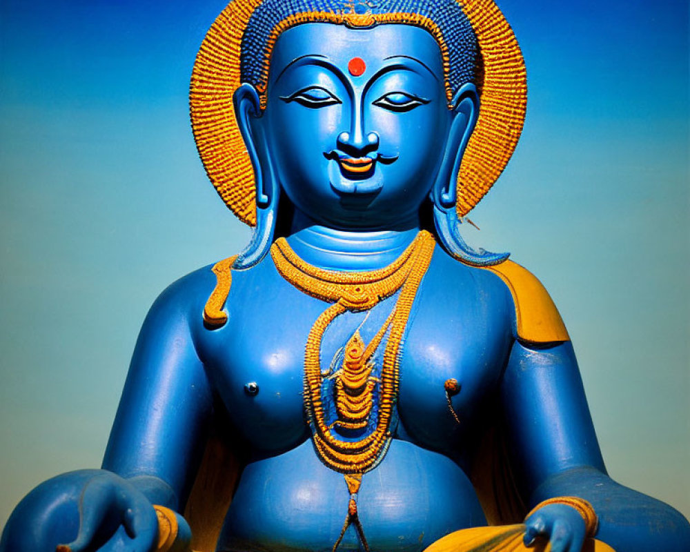 Colorful Four-Faced Deity Statue in Meditative Pose