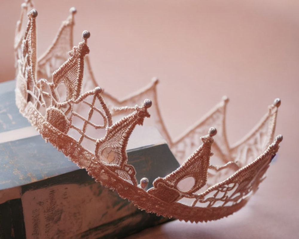 Rose Gold Tiara with Lace Filigree and Bead Accents on Vintage Books Against Blush