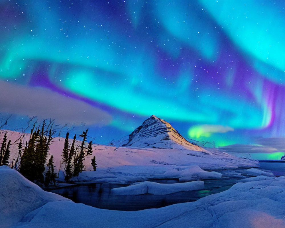 Majestic aurora borealis over snowy mountain landscape