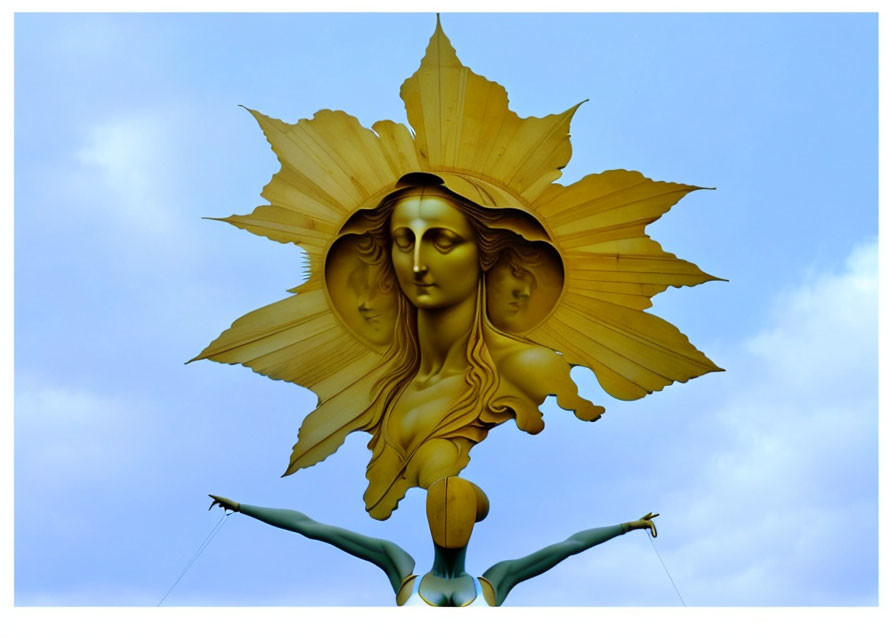Golden sculpture of serene woman's face with pointed leaf halo, supported by metallic blue human arms against blue