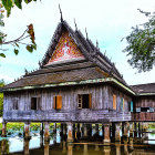 Blue Temple Surrounded by Lake and Lush Greenery