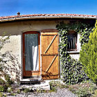 Whimsical house with open door in nature under dreamy sky