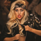 Person with Dramatic Makeup and Ornate Headpiece in Black and Gold Attire poses against Blurred