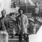 Men with dreadlocks in joyful black and white group photo