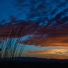 Vibrant Stained Glass Window of Sunset Landscape