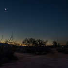 Digital Artwork: Crescent Moon Over Mountainous Landscape