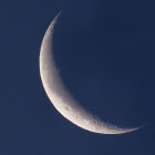 Paper art: Crescent moon & birds in flight on blue background