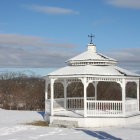 Colorful paper quilling art: Whimsical gazebo and floral patterns under blue sky