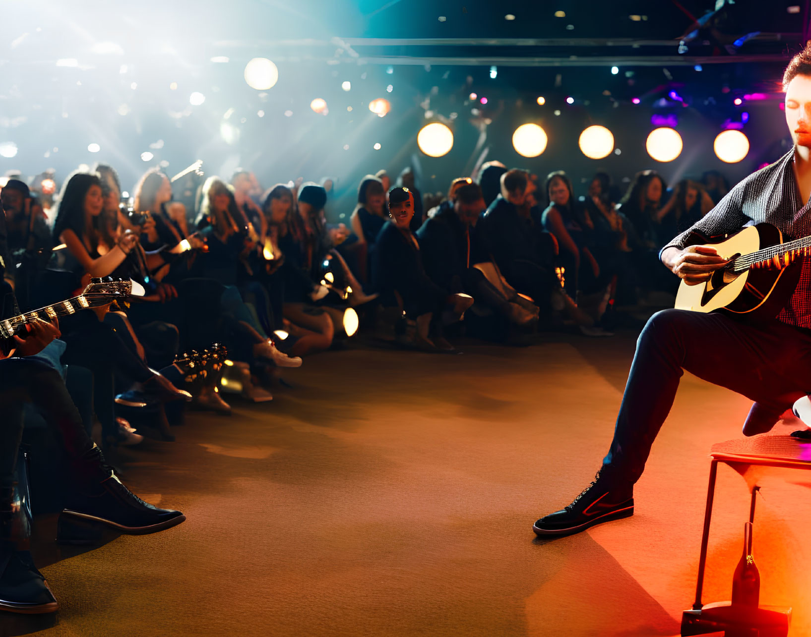 Live acoustic guitar performance under warm stage lights