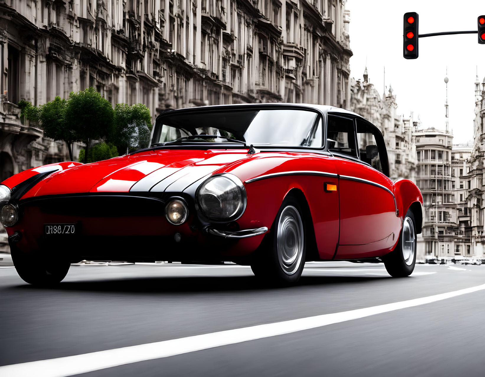 Vintage red convertible car driving through urban street with blurred cityscape.