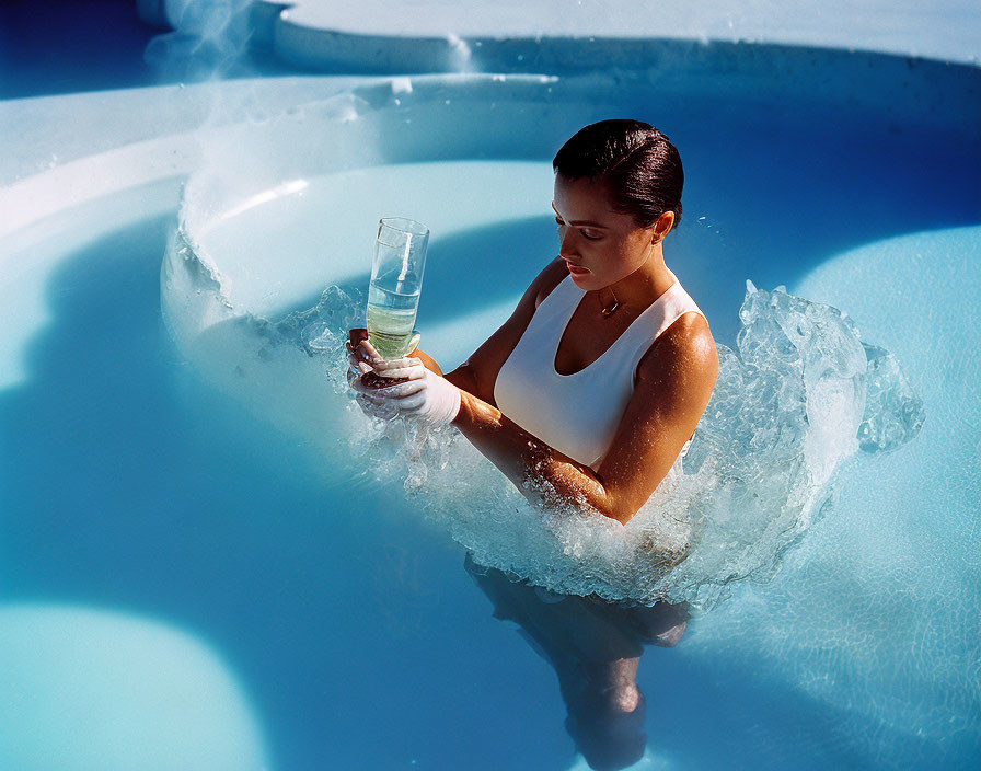 Woman in hot tub with glass of water under sunlight glare