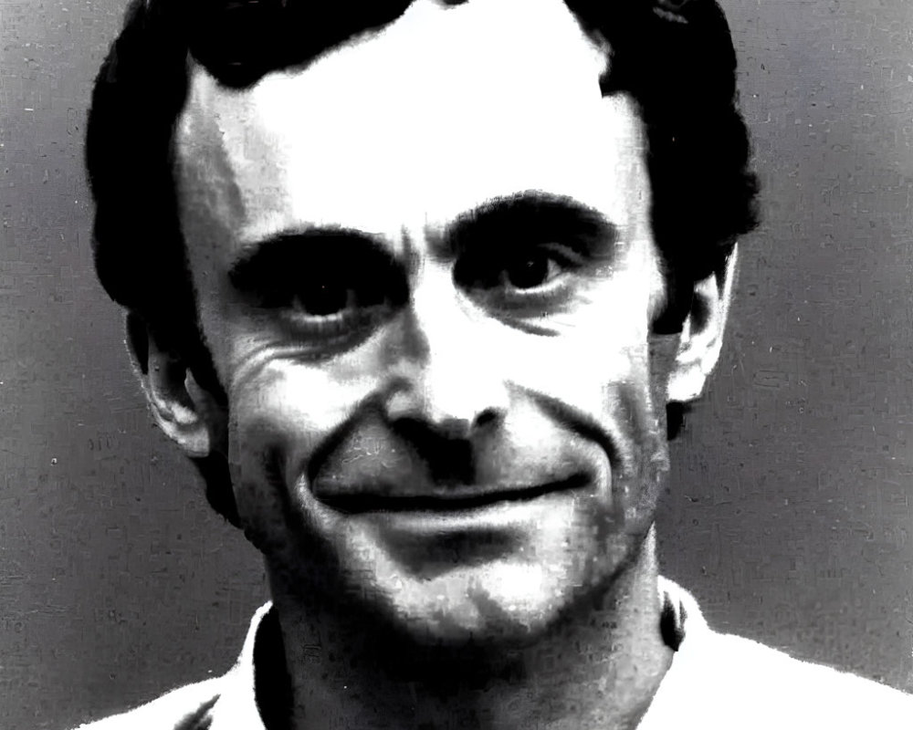 Smiling man with intense eyes in black and white photo