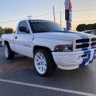 Vintage White Pickup Truck with Blue Neon Underglow at Twilight Car Show