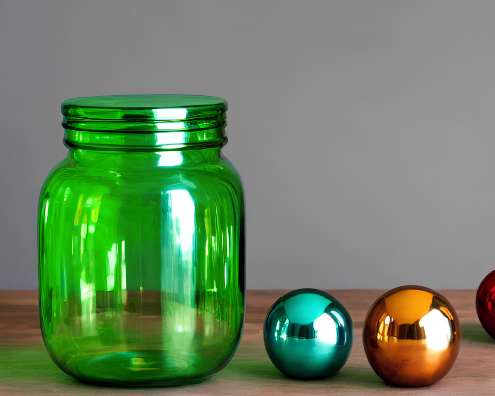 Large Green Glass Jar with Reflective Decorative Spheres on Wooden Surface