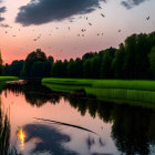 Tranquil river scene at twilight with flying birds and silhouetted trees