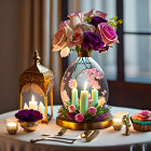 Table setting with candles, lantern, floral centerpiece, and cupcake by window