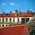 Digital watercolor painting of charming historical building rooftops and blue sky