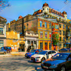 Colorful Vintage Cars Parked in Front of Ornate Buildings on Sunny Autumn Day