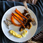 Sliced Pumpkin Gourmet Dish with Herbs and Seeds on White Plate