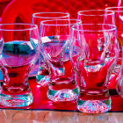 Colorful Still Life with Glassware, Oranges, and Flower on Fabric Background