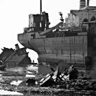 Abandoned ships with peeling paint in calm water landscape