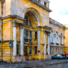 Digitally watercolored elegant building with grand archway and bright yellow walls