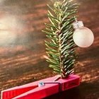 Woman in bulb-like structure near glowing Christmas tree on snowy platform