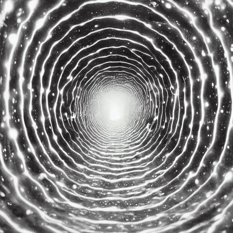 Monochrome photo of concentric circles with tunnel effect and bright light