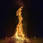 Skeleton with Halo in Fiery Explosion on Dark Background