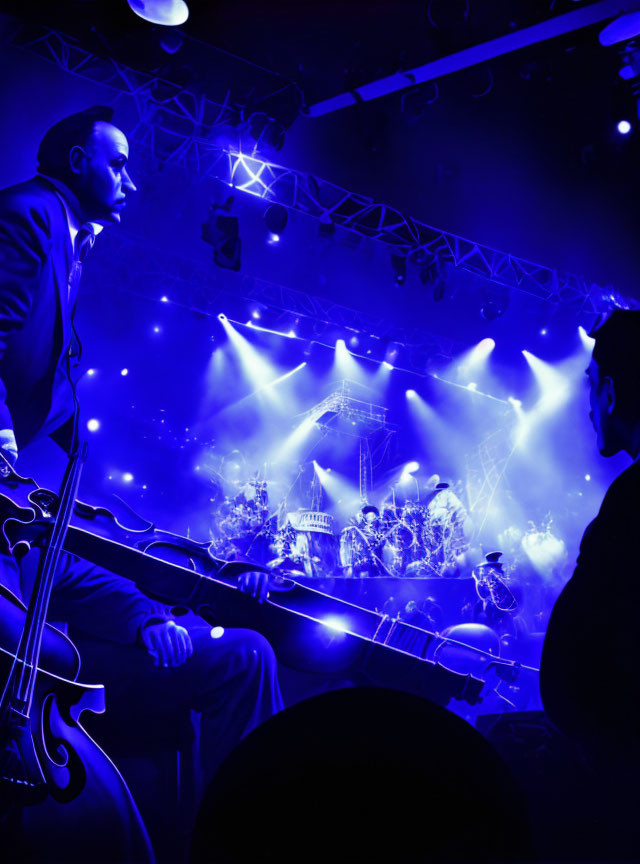 Musician performs on stage with double bass under blue lights