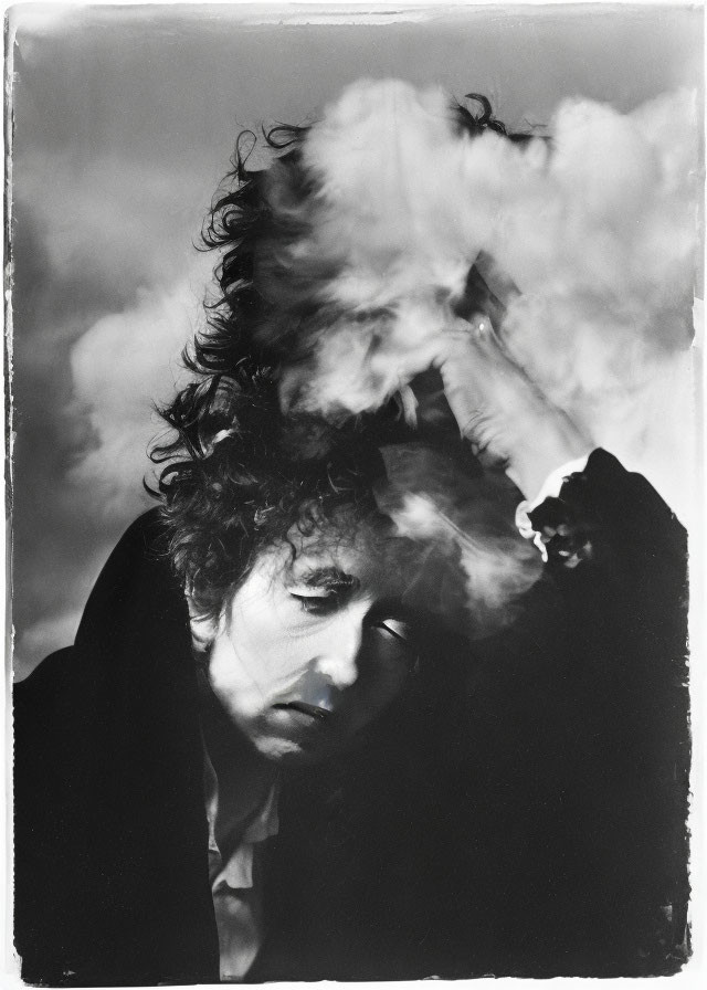 Monochrome portrait of thoughtful individual with curly hair in smoke cloud