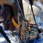 Dramatic painting: Overcrowded sailboat in rough seas