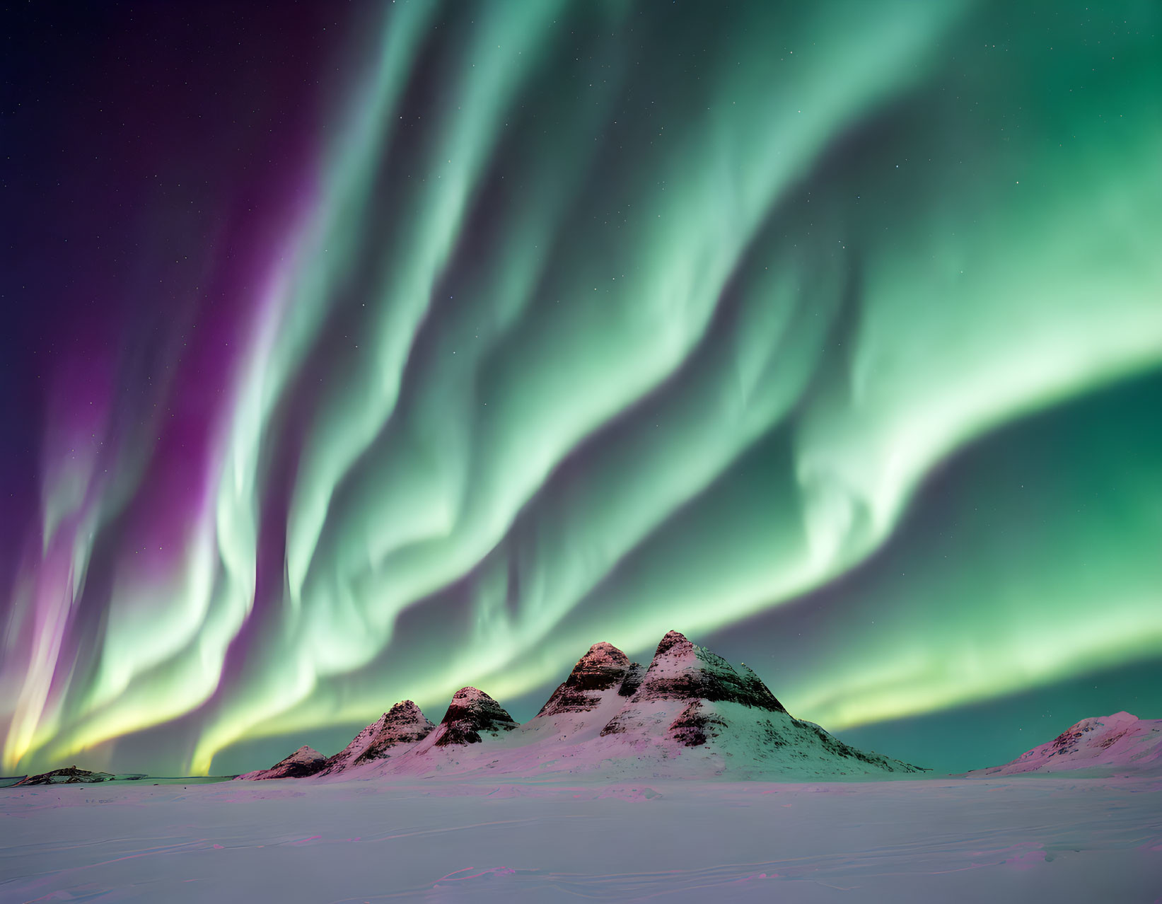 Vibrant Northern Lights Dance over Snowy Mountains