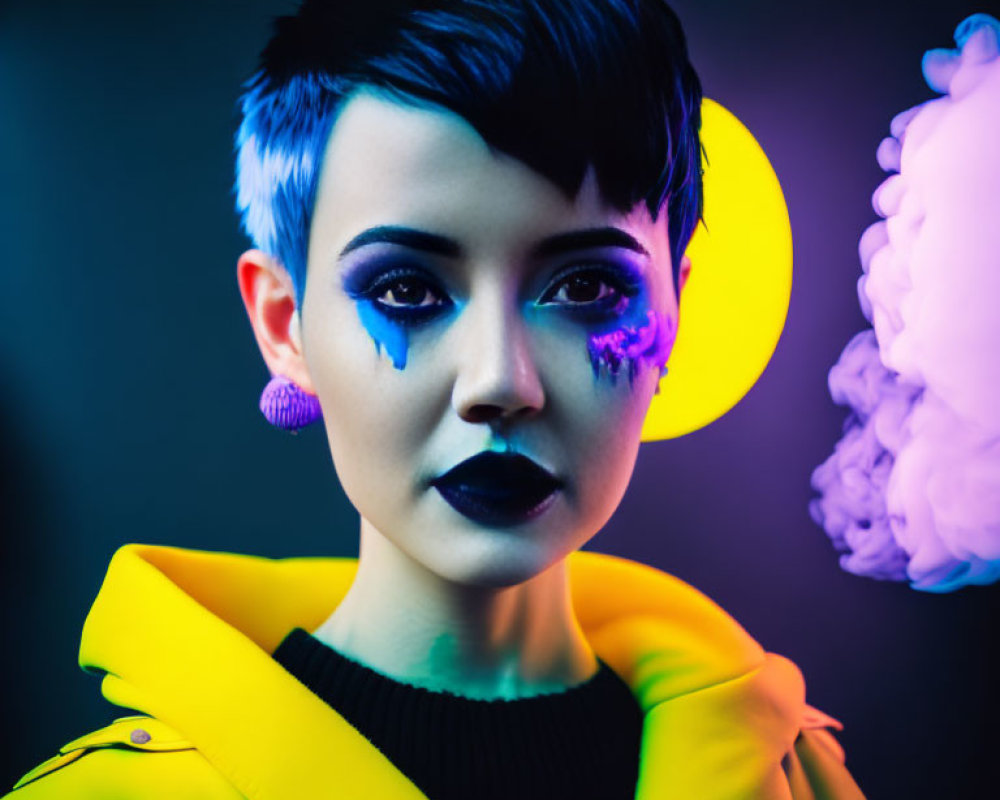 Creative makeup look with teardrop designs, short dark hair, purple earrings, yellow jacket, neon