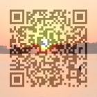 Mountain sunset pixelated QR code over water landscape.