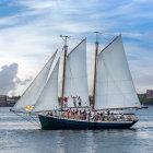 Sailing ship painting with billowed white sails on wavy blue ocean