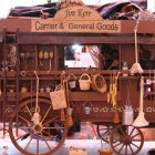 Decorative wooden cart with flowers, baskets, pottery, and lanterns in village scene