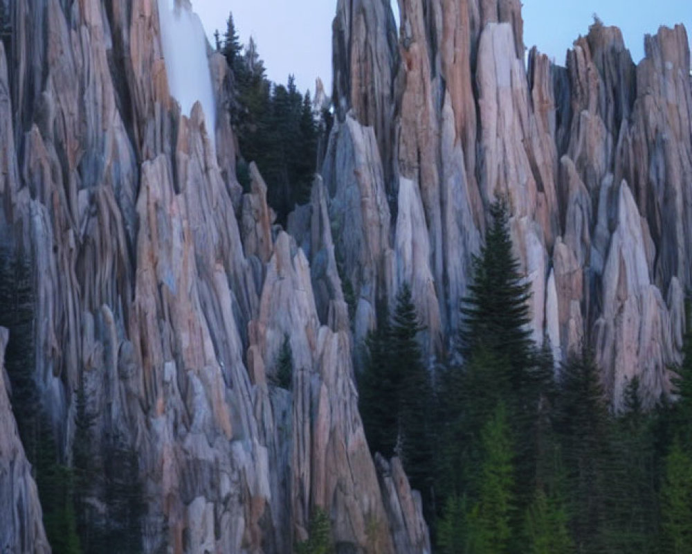 Rock formations and forest reflected in still water under a dusk sky with full moon.