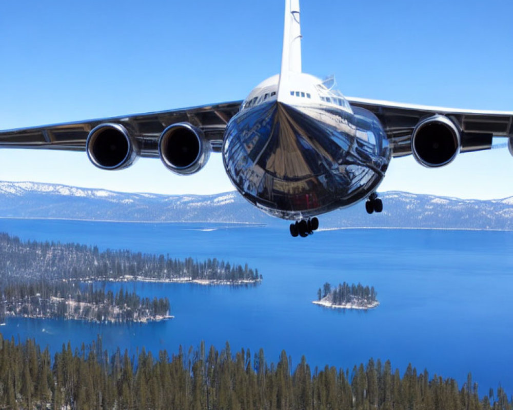 Low-flying airplane over serene lake and forest landscape