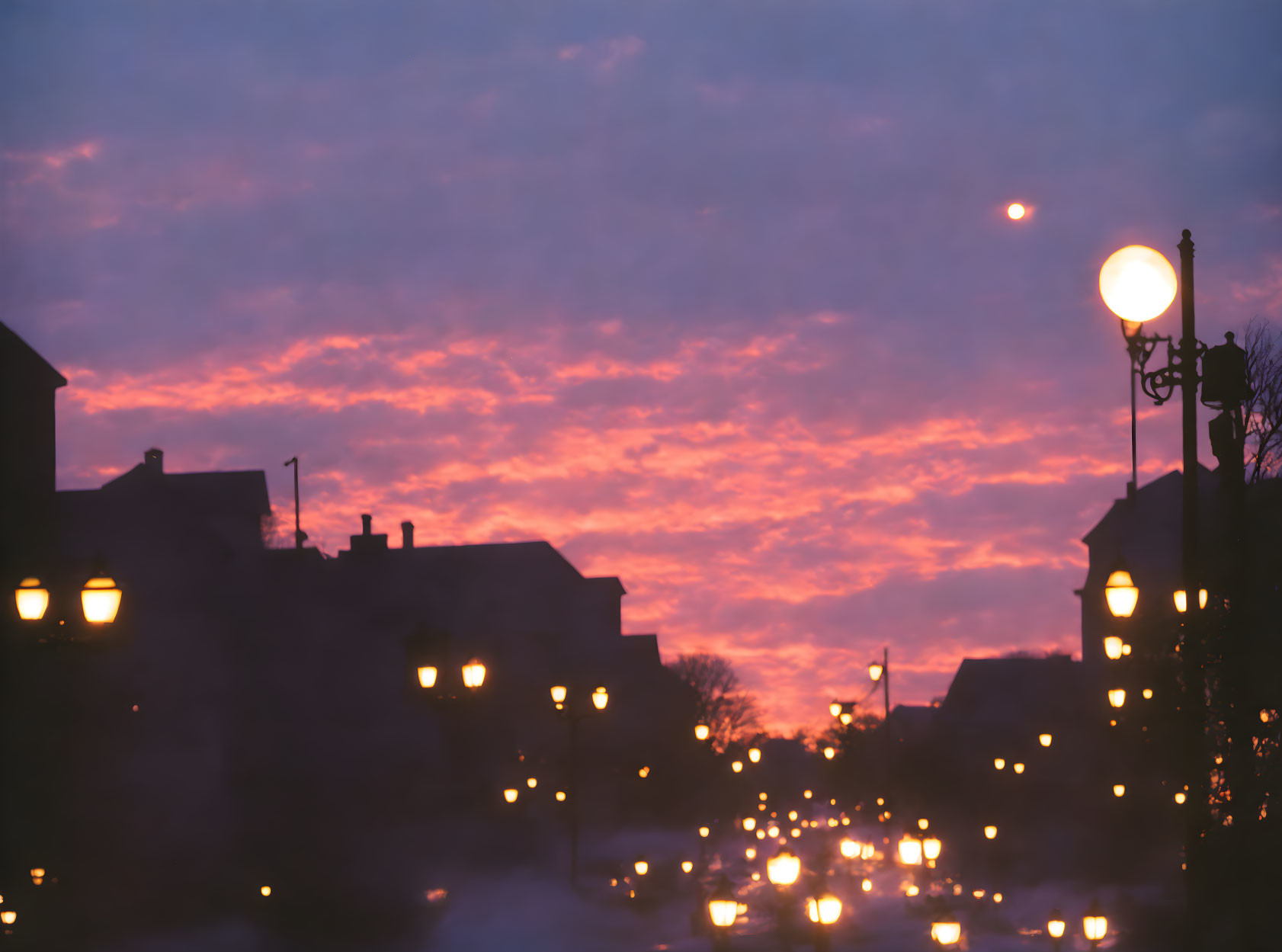 Dusky Street Scene with Glowing Street Lights and Sunset Sky