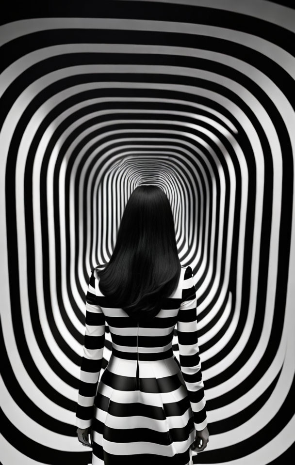 Long-haired person in striped dress stands in optical illusion tunnel