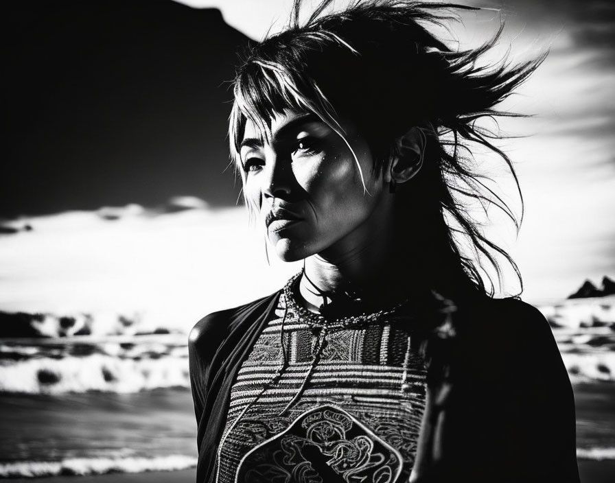 Monochrome portrait of woman with windswept hair on beach