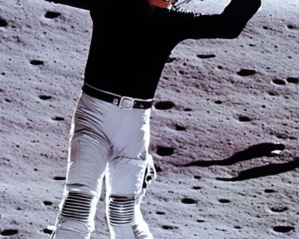 Person in Black Jacket and White Pants Smiling and Waving on Rocky Surface