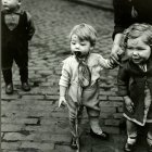 Three people in haunting costumes in a graveyard, one as a skeleton with a staff.